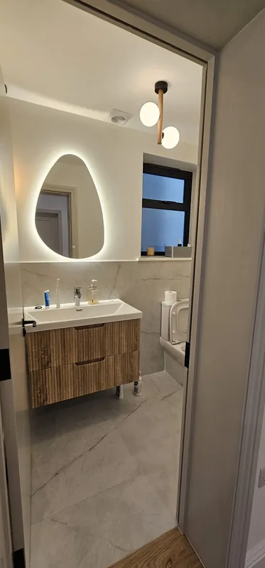 Bathroom: Backlit mirror, wall light and downlights