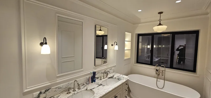 Bathroom: Wall lights, a pendant and a lit niche around a freestanding bath