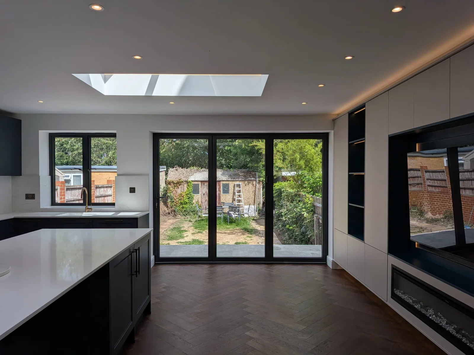 Kitchen extension: Downlights and LED-lit rooflights over an open-plan kitchen