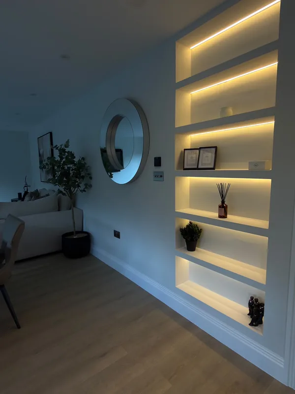 Living room: Recessed shelving lit with warm LED strips