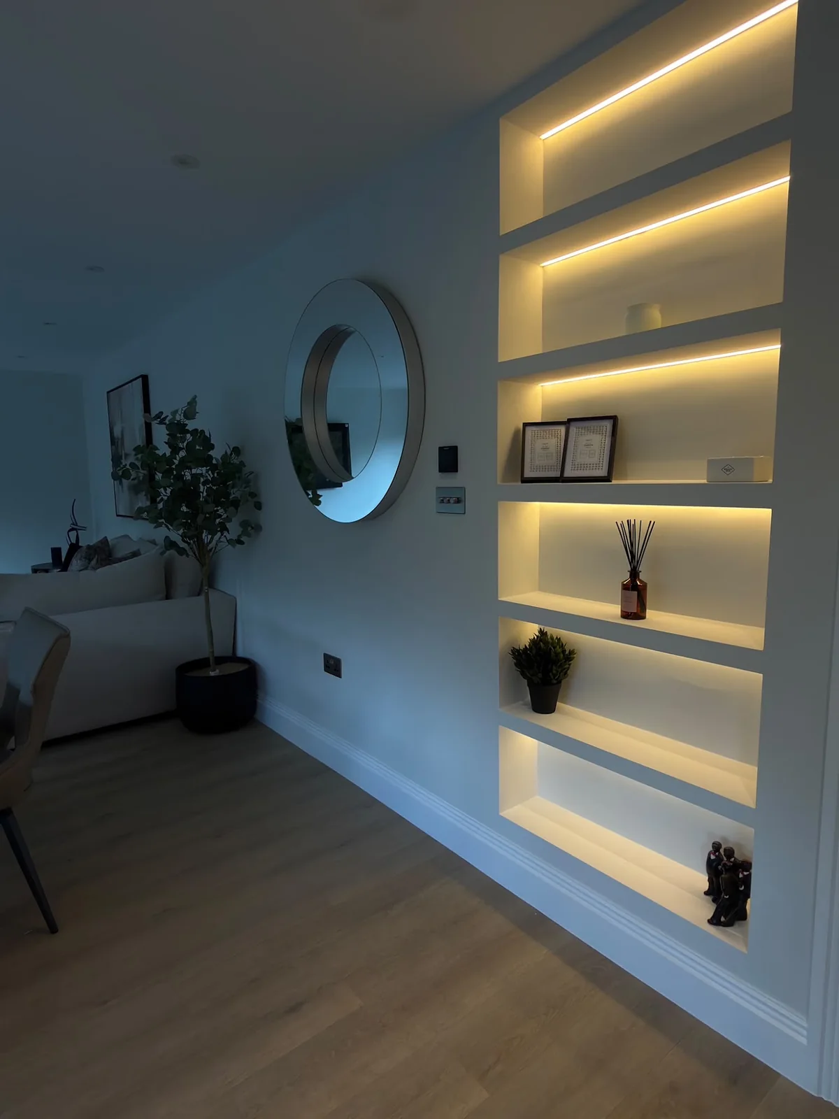 Living room: Recessed shelving lit with warm LED strips