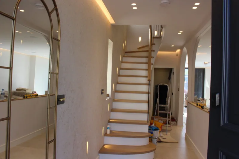 Hallway: LED cove lighting and a lit staircase