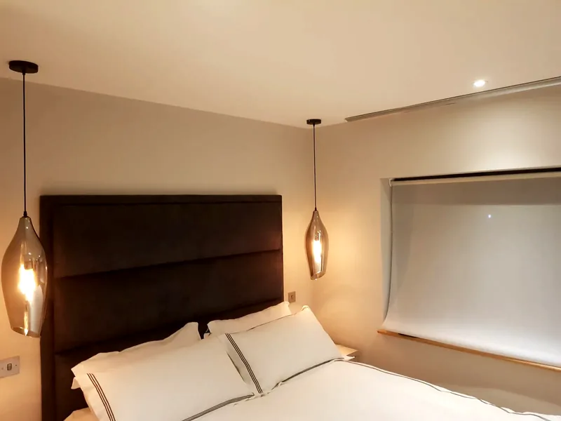Bedroom: Pendant lights either side of the bed, with downlights