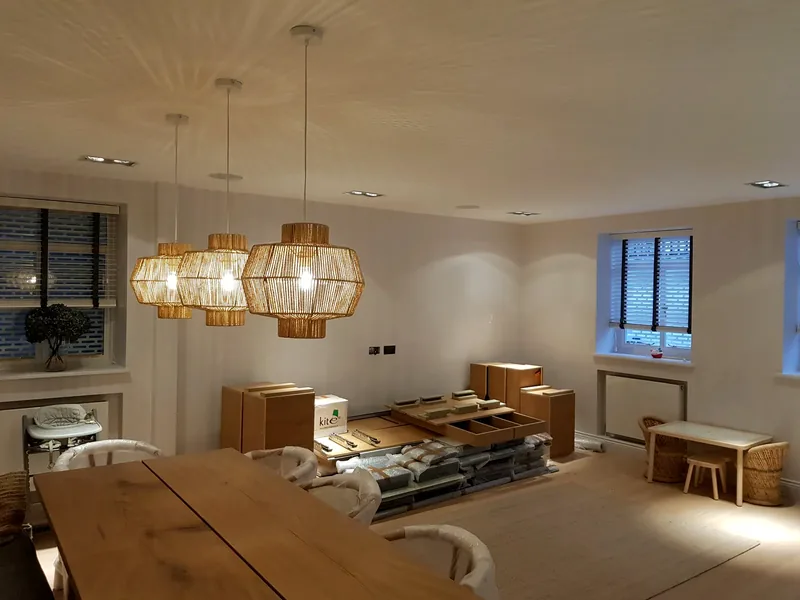 Dining room with three woven pendant lights and downlights