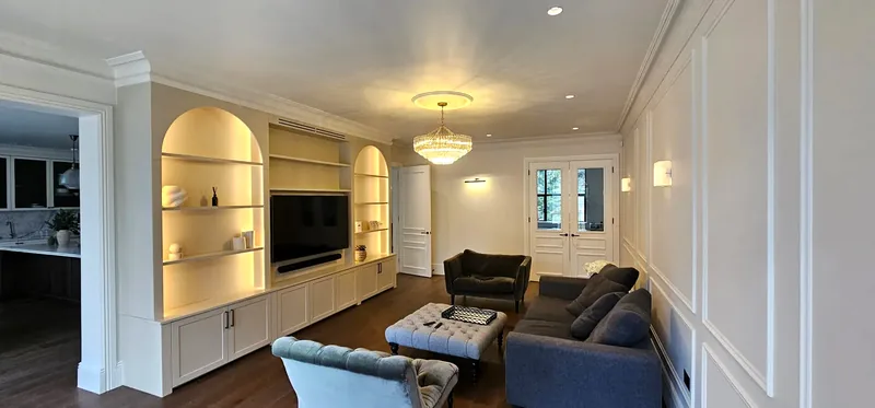 Living room: Lit arched alcove shelving, a crystal chandelier and wall lights