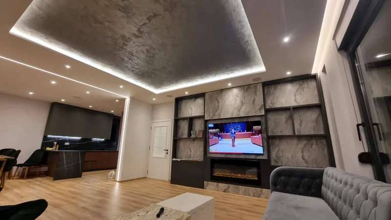 Media room: LED ceiling coffer, downlights and a media wall